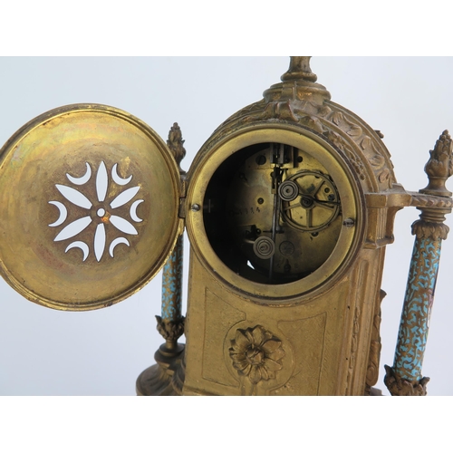 1268 - A late 19th century gilt metal and champlevé enamel mantel clock, of arched outline with urn finial,... 