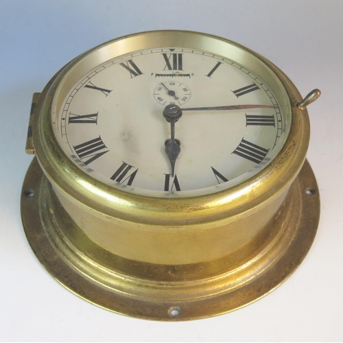 1275 - A brass cased bulkhead timepiece, with 14cm silvered Roman dial with subsidiary seconds dial, 20.5cm... 