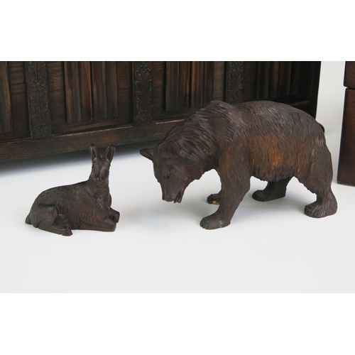 1285 - A Black Forrest carved linden wood model of a bear, 15cm long, a similar model of a deer, a miniatur... 