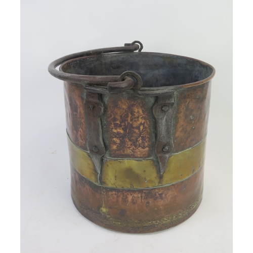 1292 - A 19th century brass and copper log bin of cylindrical form, with steel loop handle, 35cm high, 36cm... 