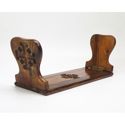 1299 - A Victorian olive wood sliding book rack, in the gothic taste, 
37cm  unextended.