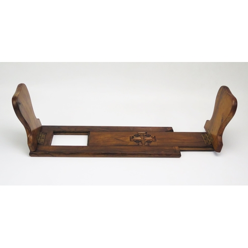 1299 - A Victorian olive wood sliding book rack, in the gothic taste, 
37cm  unextended.