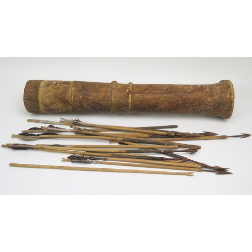 1303 - A Sudanese hide quiver of cylindrical form with pull-off top containing steel tipped arrows.