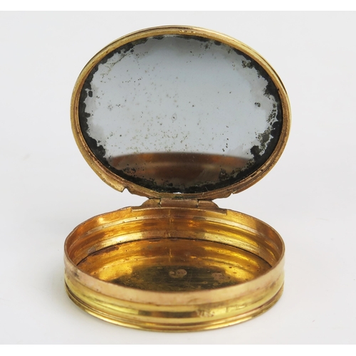 1310 - A late 18th / early 19th century gilt copper patch box, of oval outline, the hinged lid decorated wi... 