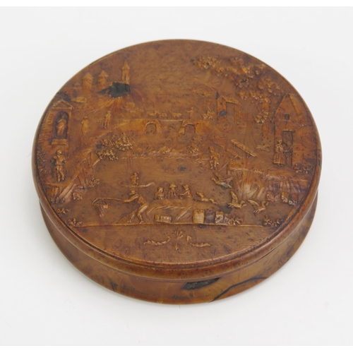 1317 - A 19th century pressed maple snuff box, of circular form the lid decorated with a riverside village ... 