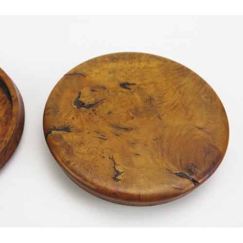 1317 - A 19th century pressed maple snuff box, of circular form the lid decorated with a riverside village ... 