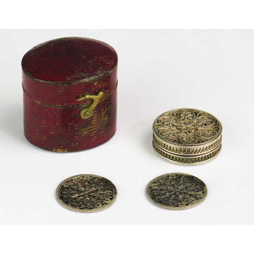 1320 - A 19th century silver filigree counter holder of circular form, containing two filigree counters, co... 