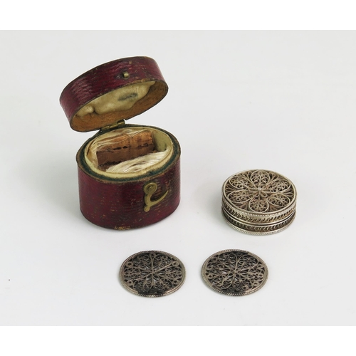 1320 - A 19th century silver filigree counter holder of circular form, containing two filigree counters, co... 