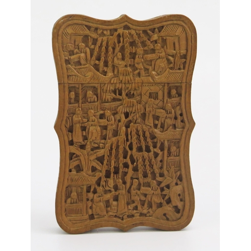 1325 - A Chinese carved sandal wood visiting card case, with pull-off top, carved with figures in a pagoda ... 