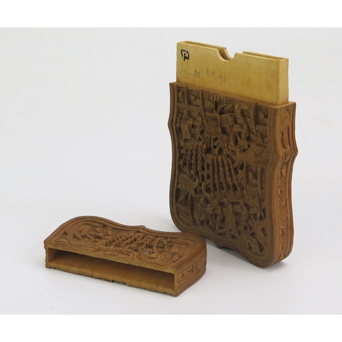 1325 - A Chinese carved sandal wood visiting card case, with pull-off top, carved with figures in a pagoda ... 