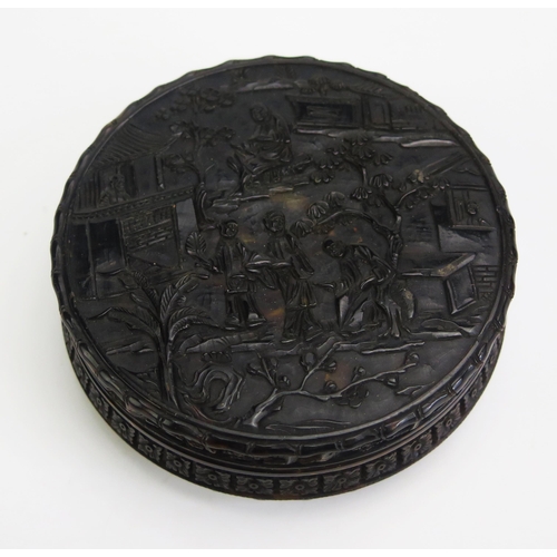 1327 - A 19th century Chinese carved tortoiseshell snuff box of circular form, with all over decoration of ... 