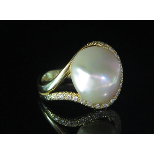 133 - An 18ct Gold, Baroque Pearl or Cultured Pearl and Diamond Ring, 19.5mm head, stamped 18K, .2ct of di... 