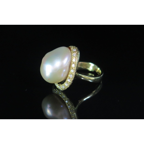 133 - An 18ct Gold, Baroque Pearl or Cultured Pearl and Diamond Ring, 19.5mm head, stamped 18K, .2ct of di... 