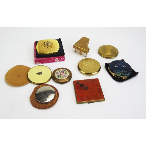 1330 - A collection of assorted ladies compacts, including boxed example, another in the form of a piano,