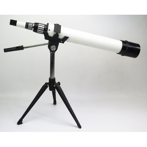 1332 - A Cherry 20X -60X telescope mounted on a folding tripod base.0verall length 64cm.