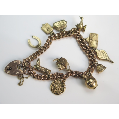 134 - A 9ct Gold Curb Link Charm Bracelet, 26.54g (two charms unmarked)