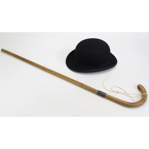 1342 - A Gents bowler hat by Dunn & Co, size 6. 7/8ths, together with a silver mounted walking cane.