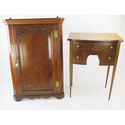 1509 - A Georgian oak hanging corner cupboard, with moulded cornice and arched panelled door enclosing shel... 