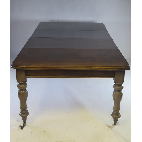 1513 - A Victorian mahogany extending dining table, the rectangular top with a moulded edge raised on turne... 