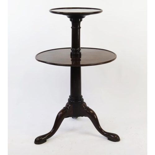 1517 - A 19th century mahogany two tier circular dumb waiter, of graduated form on a ring turned column, on... 