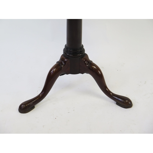 1517 - A 19th century mahogany two tier circular dumb waiter, of graduated form on a ring turned column, on... 