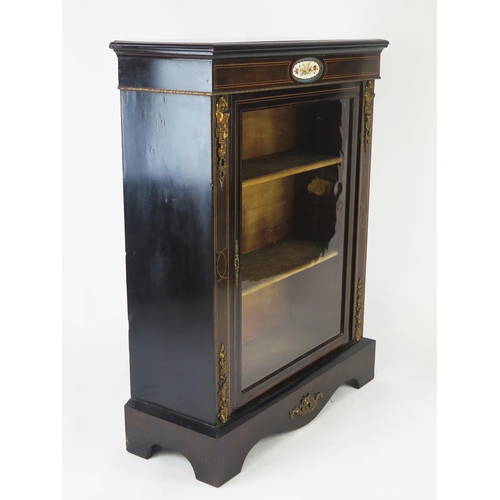 1518 - A 19th century ebonised, rosewood, and gilt metal mounted pier cabinet, the rectangular top, above a... 