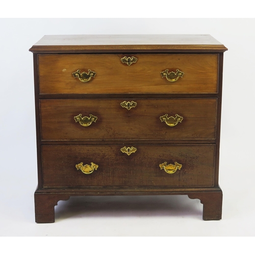 1522 - A Georgian mahogany chest, the rectangular top with a moulded edge above three long drawers raised o... 