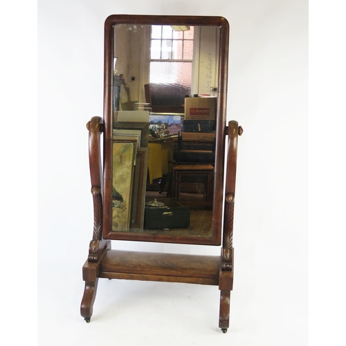 1525 - A Victorian walnut cheval mirror, the rectangular mirror plate within scrolled supports, the platfor... 