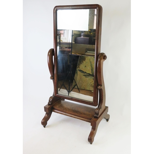 1525 - A Victorian walnut cheval mirror, the rectangular mirror plate within scrolled supports, the platfor... 