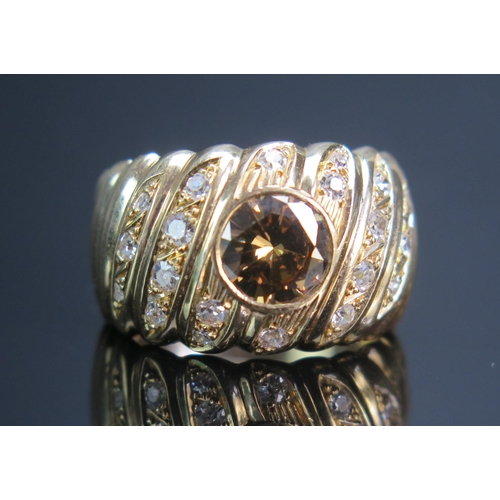 153 - A Fancy Orange Brown 1.31ct Diamond Ring in a precious yellow metal setting with twenty graduated br... 