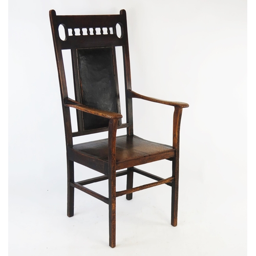 1531 - A 19th century elm elbow chair, with galleried top rail, padded panelled back above a solid seat, ra... 