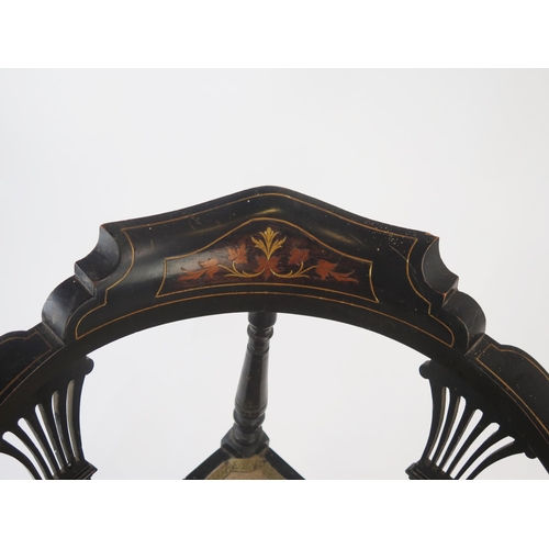 1534 - A late Victorian ebonised and inlaid corner chair, of serpentine outline with padded seat, on turned... 