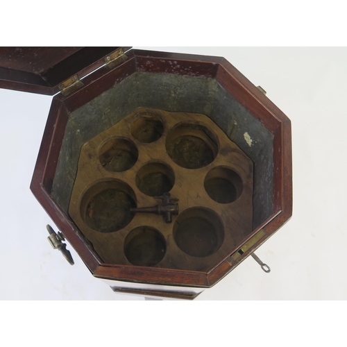 1536 - A George III mahogany and brass bound wine cooler, of octagonal outline, the hinged lid enclosing  a... 