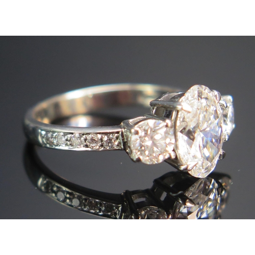 154 - An 18th White Gold and Diamond Three Stone Ring, the c. 10.2x7mm laboratory diamond with laser etche... 