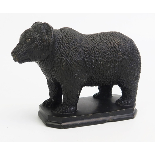 1548 - A carved hardstone model of a bear, in the Black Forest style, with inset glass eyes, on a rectangul... 