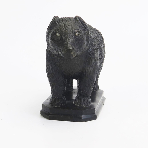 1548 - A carved hardstone model of a bear, in the Black Forest style, with inset glass eyes, on a rectangul... 