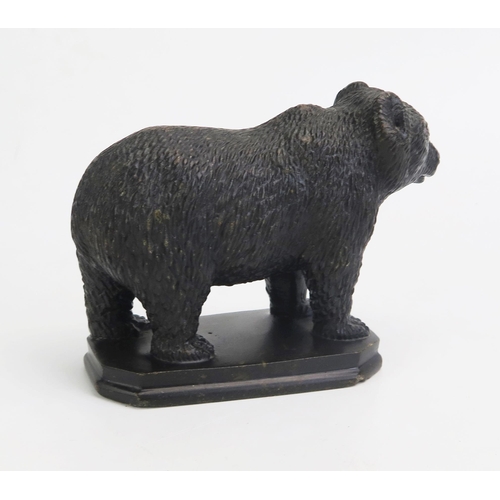 1548 - A carved hardstone model of a bear, in the Black Forest style, with inset glass eyes, on a rectangul... 