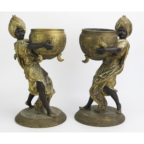 1549 - A pair of late 19th century painted spelter jardinières in the form of Blackamoors holding large cau... 