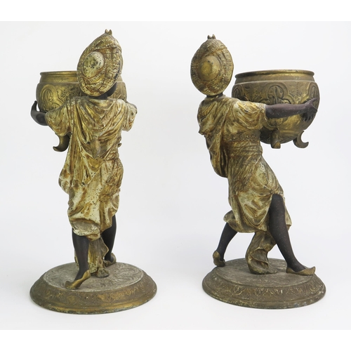 1549 - A pair of late 19th century painted spelter jardinières in the form of Blackamoors holding large cau... 