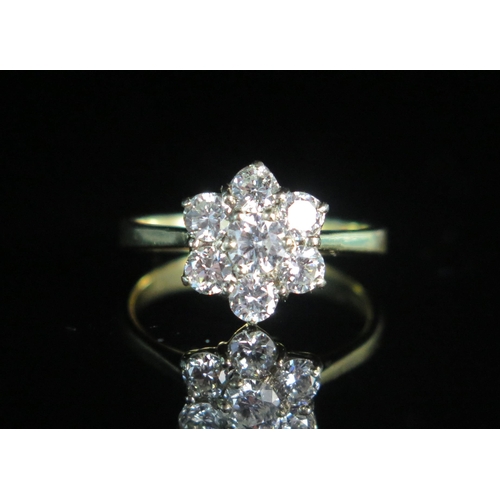 155 - An 18ct Gold, and Diamond Floral Cluster Ring, EDW 1.2ct, size N.5, stamped 750, 3.37g