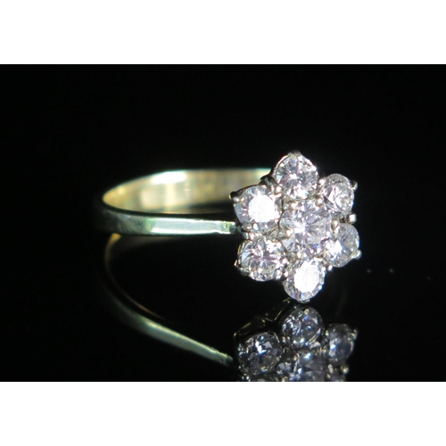 155 - An 18ct Gold, and Diamond Floral Cluster Ring, EDW 1.2ct, size N.5, stamped 750, 3.37g