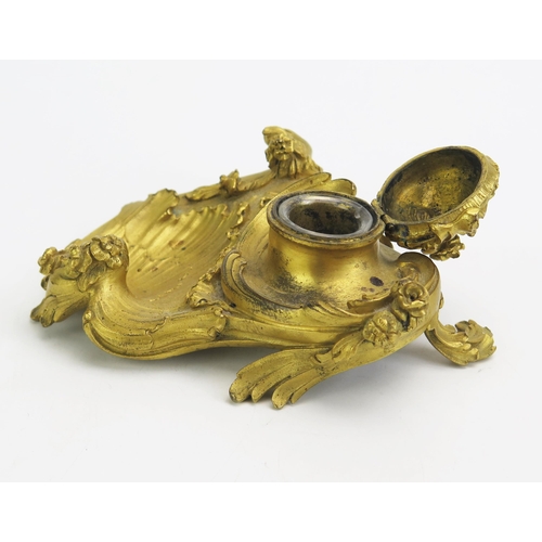 1550 - A 19th century ormolu inkwell in the Rococo style, with hinged lid, swept scrolls and flowerhead dec... 