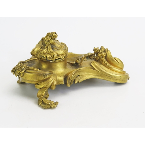 1550 - A 19th century ormolu inkwell in the Rococo style, with hinged lid, swept scrolls and flowerhead dec... 