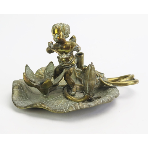 1551 - A late Victorian gilt brass pen stand, with revolving 21cm wide cherub and butterfly snuffer to a fl... 