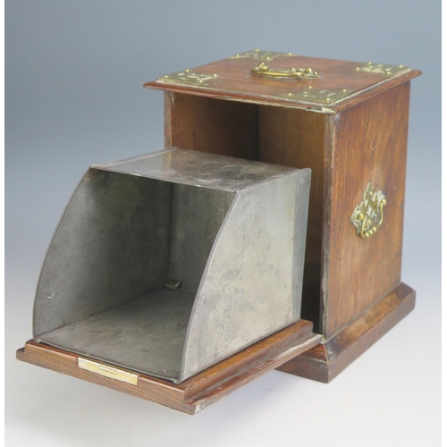 1558 - A late Victorian oak and brass bound tea caddy in the form of a coal purdonium, with hinged fall fro... 