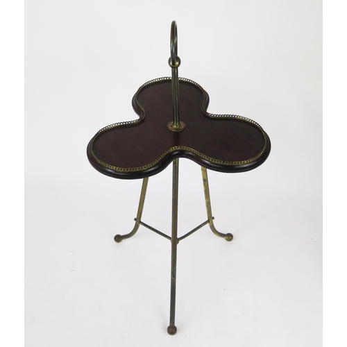 1577 - A late 19th century mahogany and gilt metal stand of trefoil outline, with galleried edge central st... 