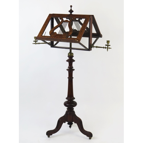 1580 - A Victorian walnut duet music stand, with hinged lyre-shaped stands, and hinged brass candlesticks, ... 