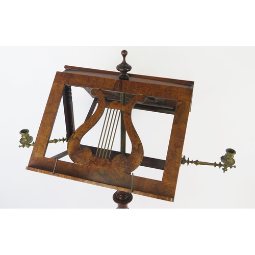 1580 - A Victorian walnut duet music stand, with hinged lyre-shaped stands, and hinged brass candlesticks, ... 