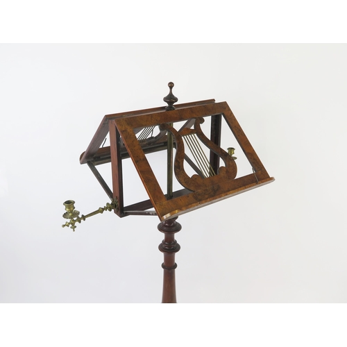 1580 - A Victorian walnut duet music stand, with hinged lyre-shaped stands, and hinged brass candlesticks, ... 