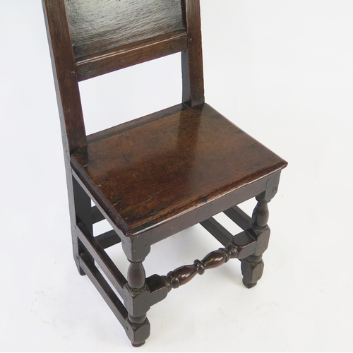 1582 - A late 18th century oak hall chair, with double arched top rail, panelled back and solid seat on tur... 